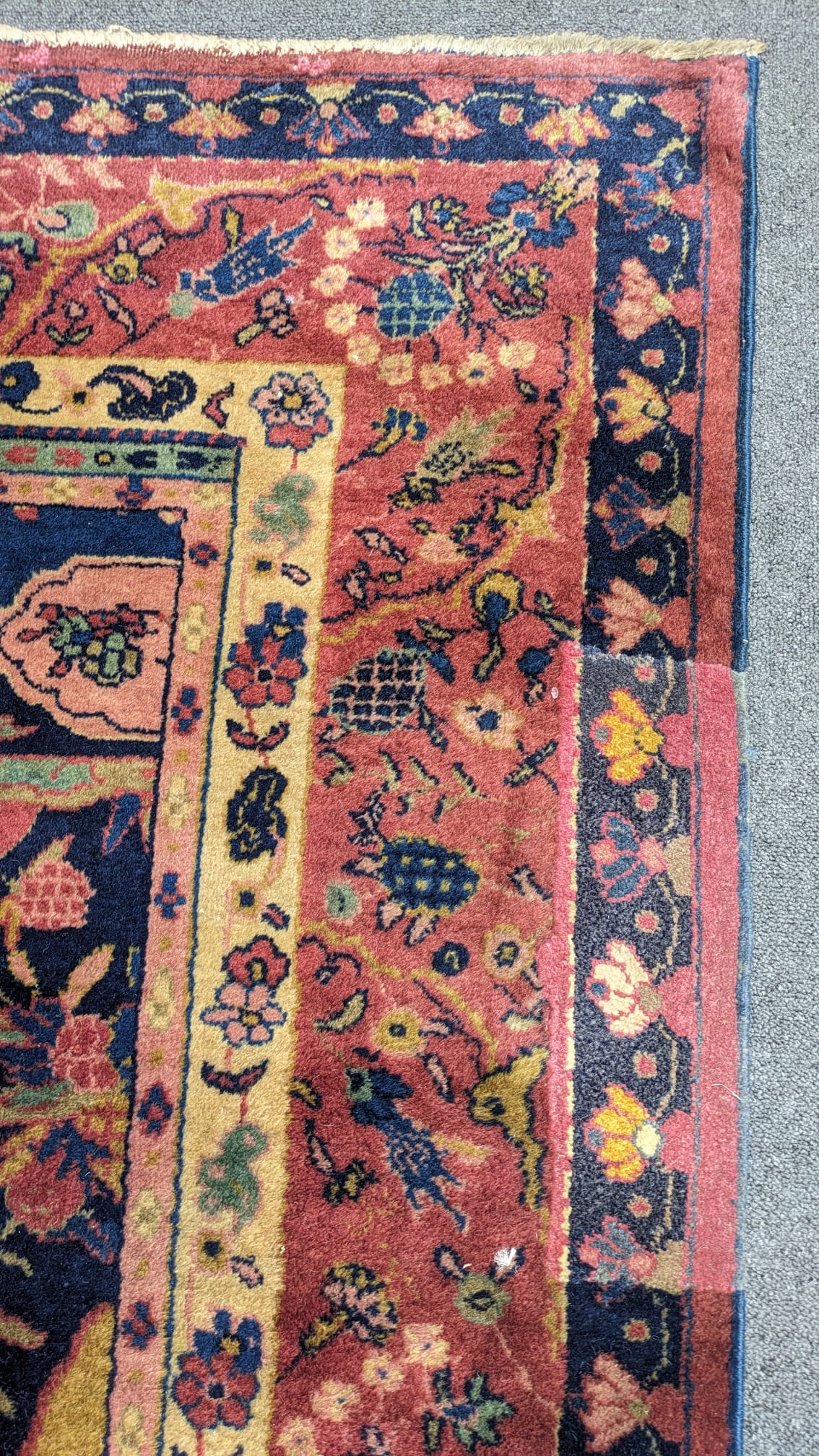 A Khorasan Mashhad red ground carpet, circa 1930’s, with field of stylised floral motif medallions, multi-bordered, 545 x 400cm. Condition - fair